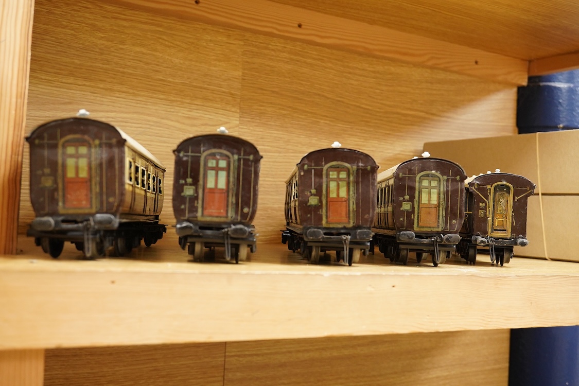 Five 0 gauge tinplate LNWR bogie coaches; four Bing for Bassett-Lowke 1921 series coaches; three Full First corridor coaches, and a Brake Third, together with a Carette 12-wheel Dining Saloon, 13210, all in chocolate and